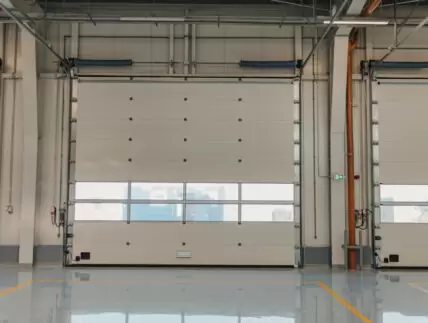 Garage rolling door in a new car workshop with resin floor.